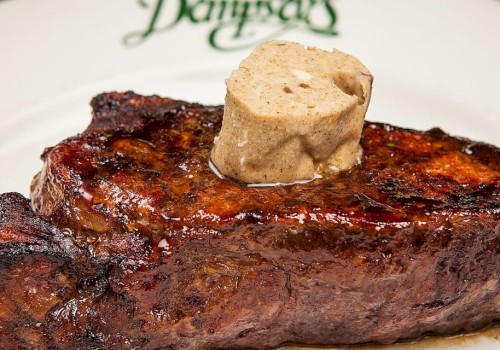 A grilled steak topped with a dollop of butter sits on a plate with the word “Donovan’s” written on the rim.